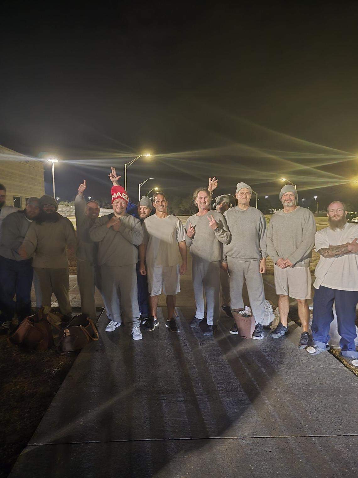 Former inmates serving time at Coleman federal prison in Wildwood in Central Florida stand outside early Tuesday morning, Jan. 21, 2025, after being released by an executive order from President Donald Trump related to the Jan. 6 attack on the U.S Capitol. All had been convicted.
