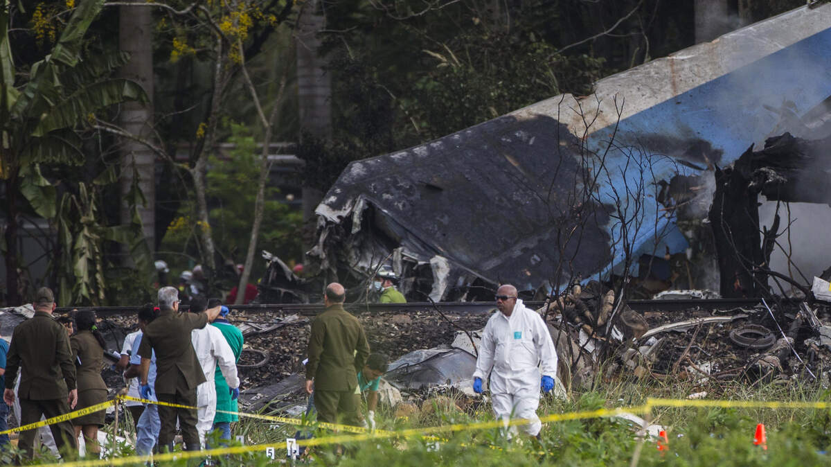 Forensic investigators sift through remains of a Boeing 737-200 that plummeted into a yucca field with more than 100 passengers on board, in Havana, Cuba, Friday, May 18, 2018. The Cuban airliner crashed just after takeoff from Havana’s international airport. (AP Photo/Desmond Boylan)