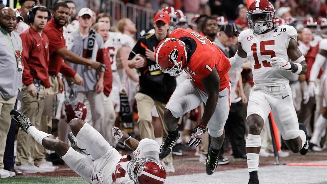 Georgia running back Sony Michel runs for a first down during the first half of the NCAA college football playoff championship game against Alabama Monday, Jan. 8, 2018, in Atlanta. The Dolphins are intrigued by Michel and Georgia’s other running back, Nick Chubb.