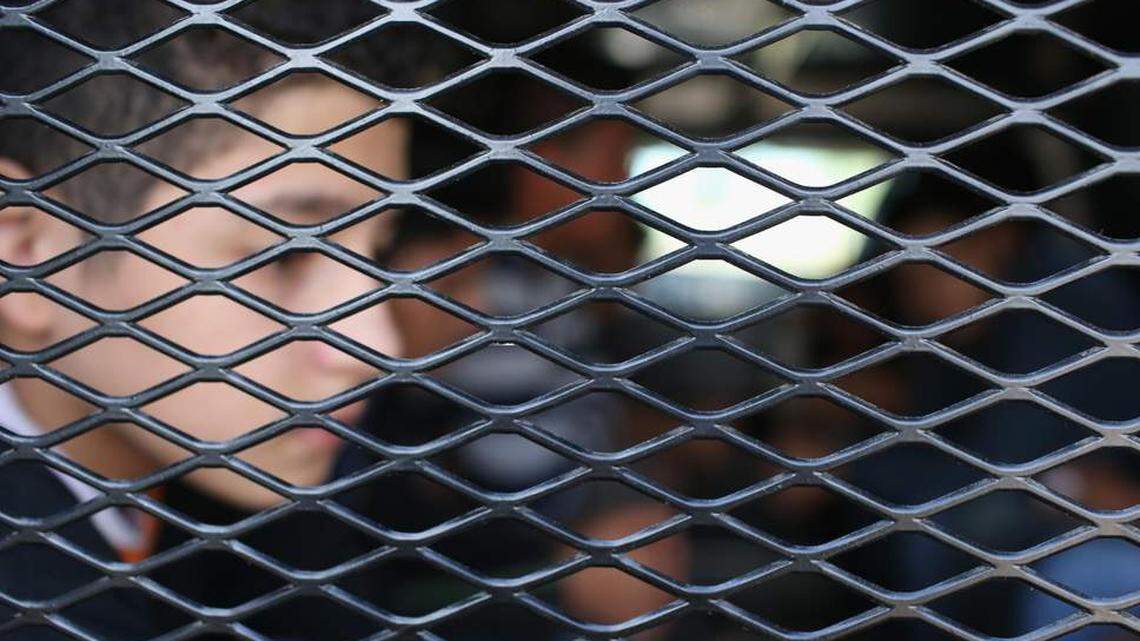 A Central American immigrant child waiting to be transported after being detained by US Border Patrol.