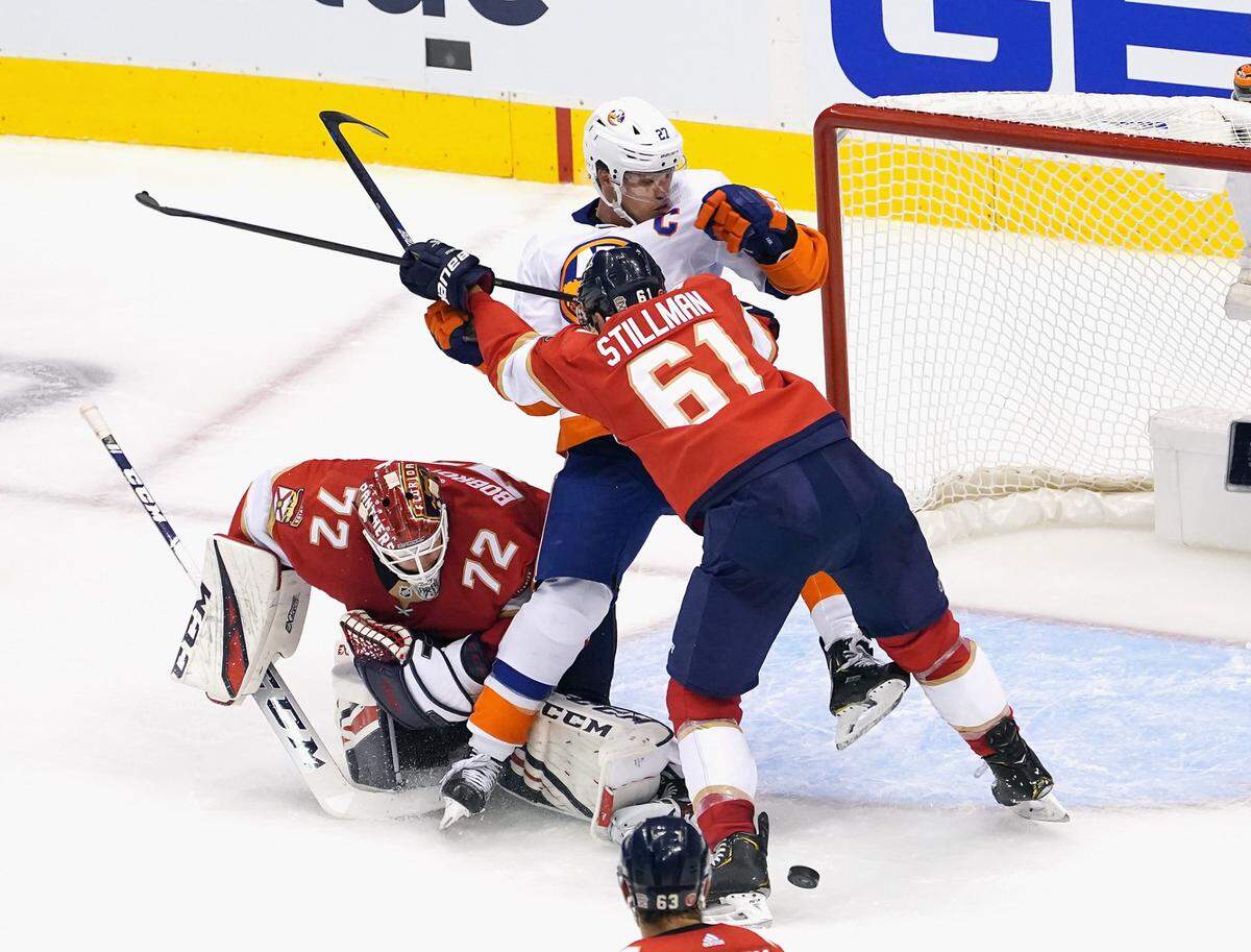 TORONTO, ONTARIO - AUGUST 05: Riley Stillman #61 of the Florida Panthers pushes Anders Lee #27 of the New York Islanders into the crease during the third period in Game Three of the Eastern Conference Qualification Round prior to the 2020 NHL Stanley Cup Playoffs at Scotiabank Arena on August 5, 2020 in Toronto, Ontario, Canada. The Panthers defeated the Islanders 3-2. (Photo by Andre Ringuette/Freestyle Photo/Getty Images)
