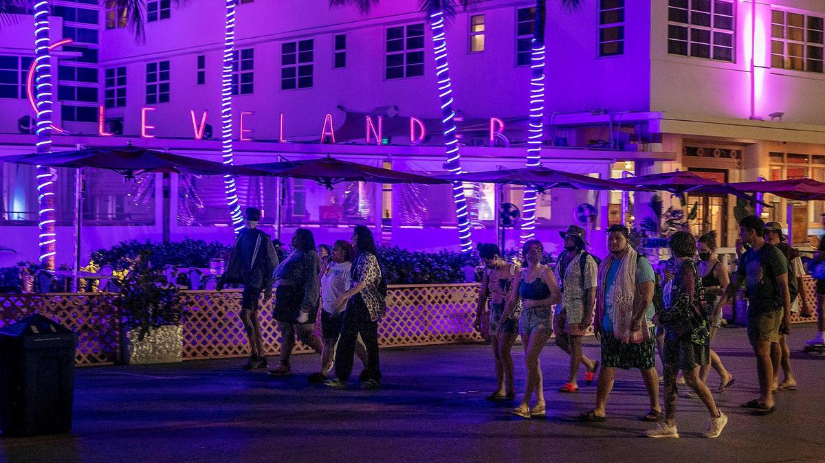 People walk by the Clevelander on Ocean Drive as spring break continues in South Beach with a smaller crowd in the streets than previous days on Wednesday, March 24, 2021.