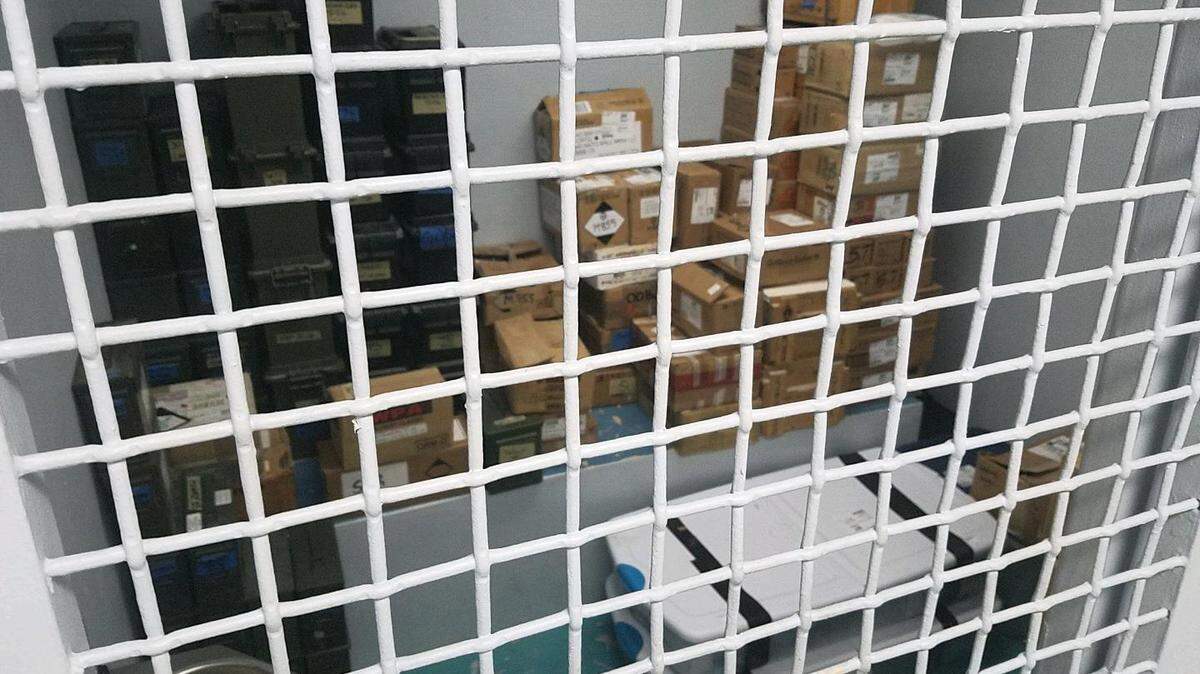 Dozens of boxes filled with almost two dozen rifles and a shotgun and thousands of rounds of ammunition have been sitting in El Portal’s lone jail cell since mid-August.