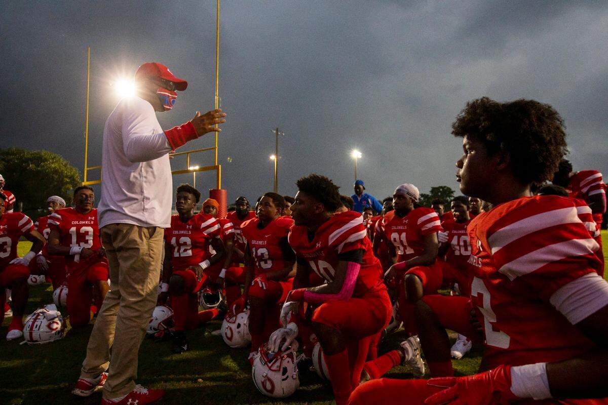 Plantation High School head coach Steve Davis speaks to his football team before the start of a high school football game against Western High at PAL Football Stadium Complex in Plantation, Florida, on Friday, October 30, 2020.