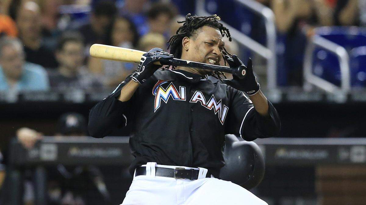 Miami Marlins starting pitcher Jose Urena (62) gets hit by the ball while attempting to bunt in the third inning as the Miami Marlins host the New York Mets at Marlins Park on Friday, August 10, 2018.