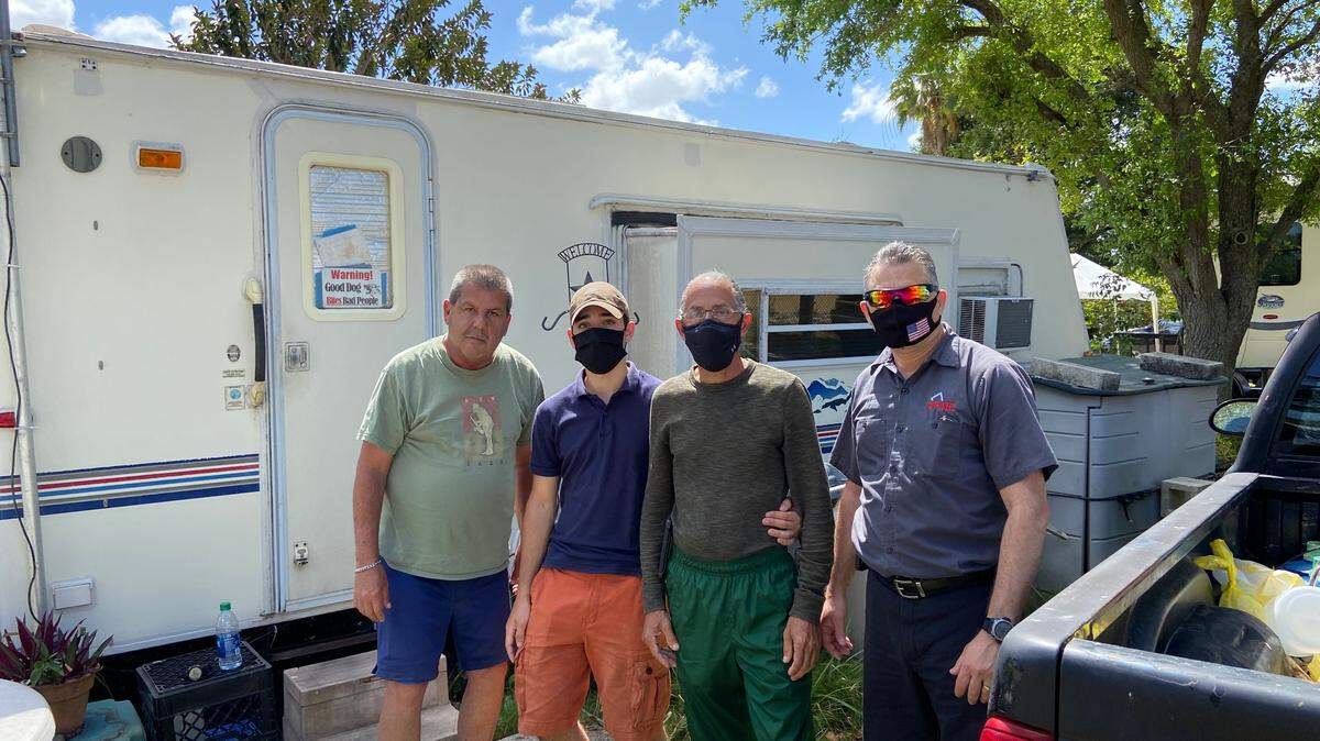 George Hernandez, Yamil Soltura, Yamil Soltura, Sr. and Kadel Marrero stand outside a camper Friday, March 12, 2021, at the Florida City Camp Site and RV Park. Florida City told all residents there they must leave by Wednesday, March 17, 2021.