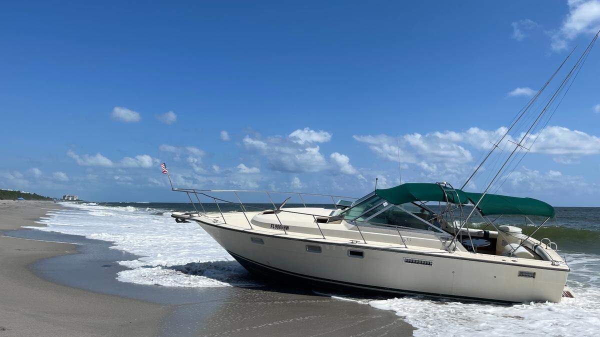 A boat is beached north of the Juno Beach pier in Palm Beach County Friday, Aug. 25, 2023. The sheriff’s office said the boat rammed one of its patrol boats, and it was carrying 14 migrants on board.