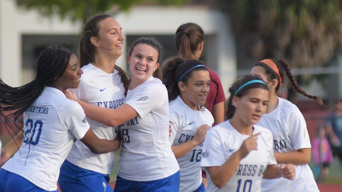 Madalyn Brouse (second from left) celebrates with teammates after scoring a goal in the first half of Cypress Bay’s regional semifinal win over Stoneman Douglas on Friday, Feb. 11, 2011, at Stoneman Douglas High in Parkland, Florida.
