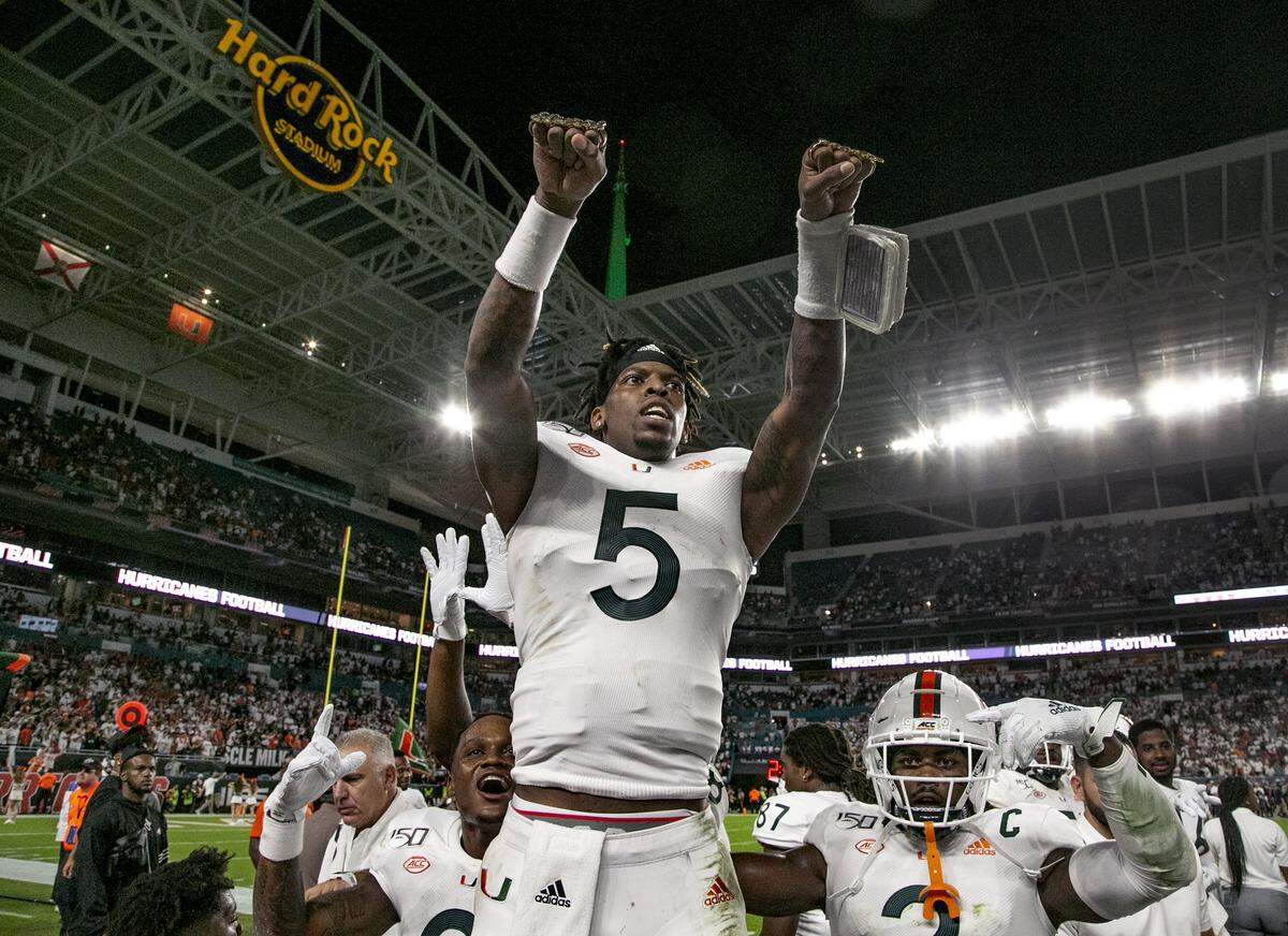 Miami quarterback N’Kosi Perry celebrates with the Touchdown Rings after scoring against Virginia at Hard Rock Stadium on Friday, October 11, 2019.