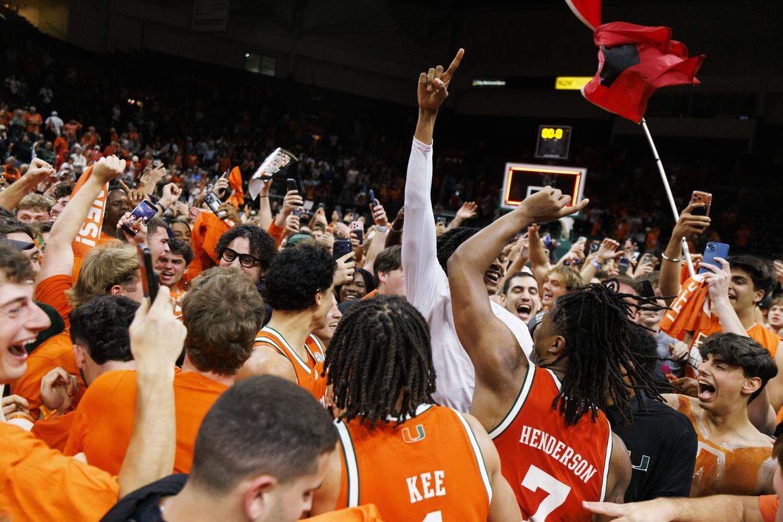Miami Hurricanes students storm the court with the team after the Hurricanes beat the North Carolina Tar Heels 75-66 on Tuesday, Feb. 10, 2026, at the Watsco Center in Coral Gables, Fla.