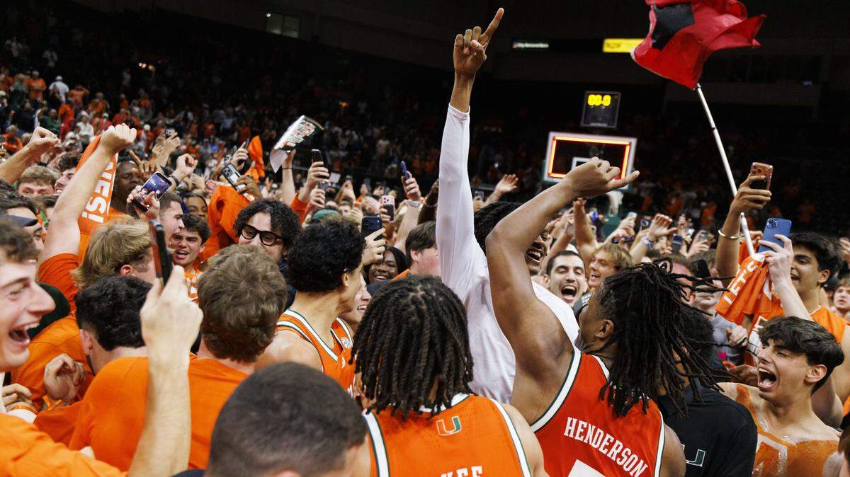 Miami Hurricanes students storm the court with the team after the Hurricanes beat the North Carolina Tar Heels 75-66 on Tuesday, Feb. 10, 2026, at the Watsco Center in Coral Gables, Fla.