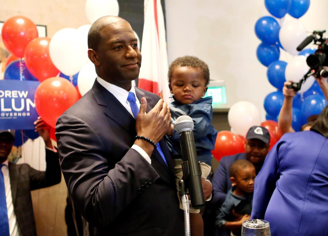 Andrew Gillum holds his son Jackson as he addresses his supporters after winning the Democratic primary for governor on Tuesday, Aug. 28, 2018, in Tallahassee.