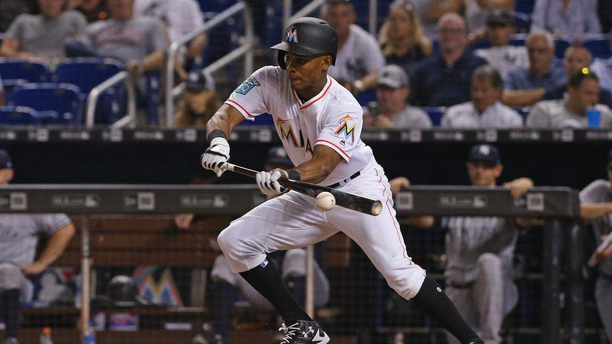 Miami Marlins center fielder Magneuris Sierra bunts during the tenth inning of a Major League Baseball interleague game against the New York Yankees at Marlins Park on Tuesday, August 21, 2018.