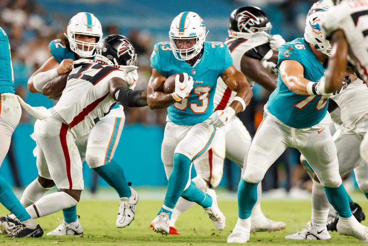 Miami Dolphins running back Chris Brooks (33) breaks the line of scrimmage for a first down in the fourth quarter against the Atlanta Falcons during a preseason game at Hard Rock Stadium in Miami Gardens on Friday, August 11, 2023.