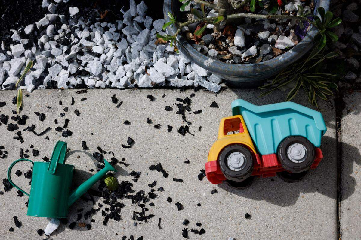 Children’s toys are strewn on the sidewalk across the street from the scene of the triple homicide that happened early Sunday morning in a quiet neighborhood in Tamarac, Fla., Tuesday, Feb. 18, 2025.