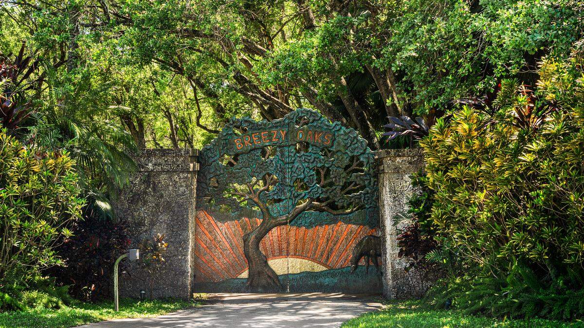 The entrance to the property has a custom copper gate that reads “Breezy Oaks.”
