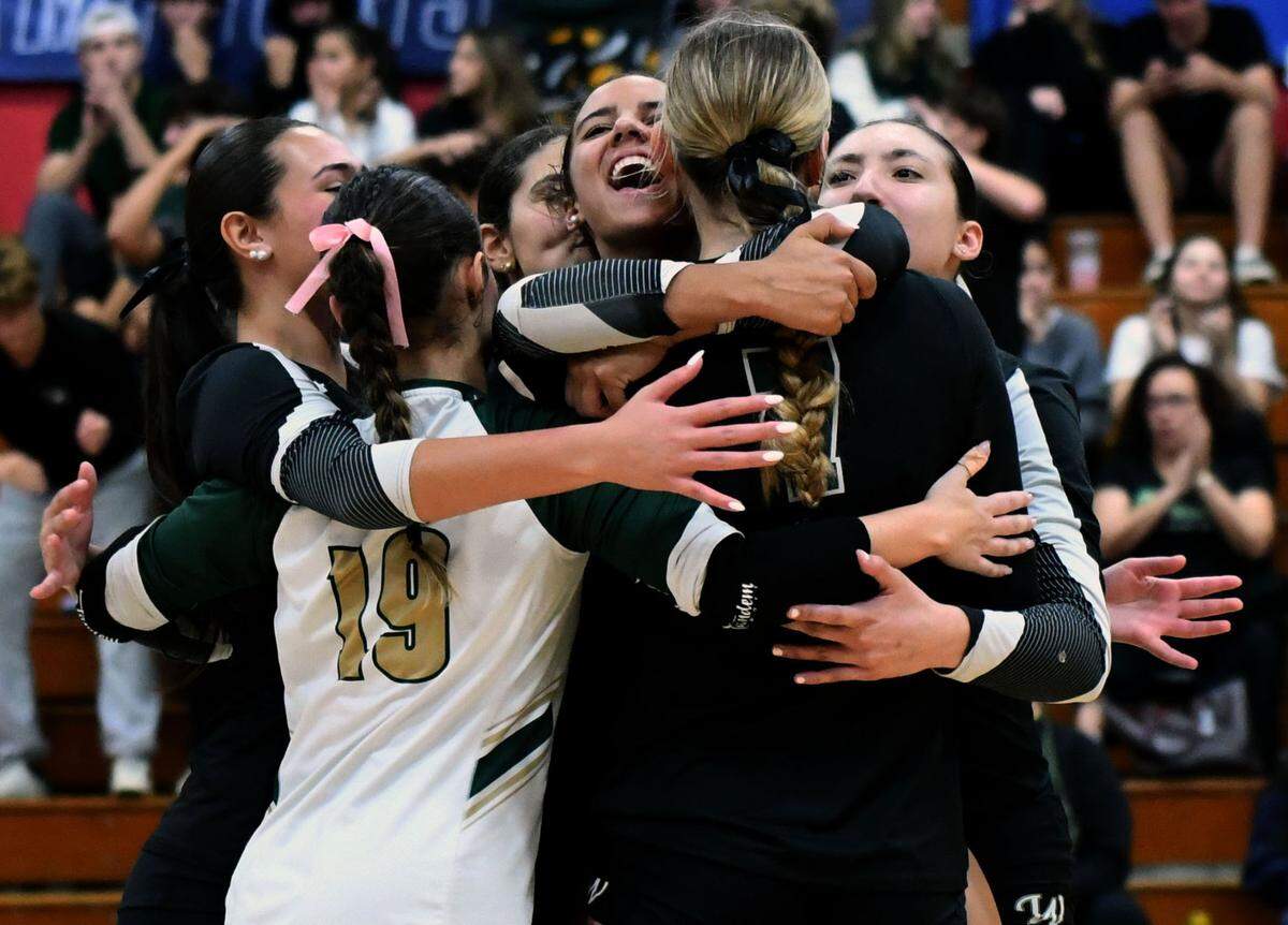 Westminster Christian players celebrate winning a critical point during the first set of the Class 2A state championship match against Ocala Trinity Catholic on Wednesday at Polk State College in Winter Haven.