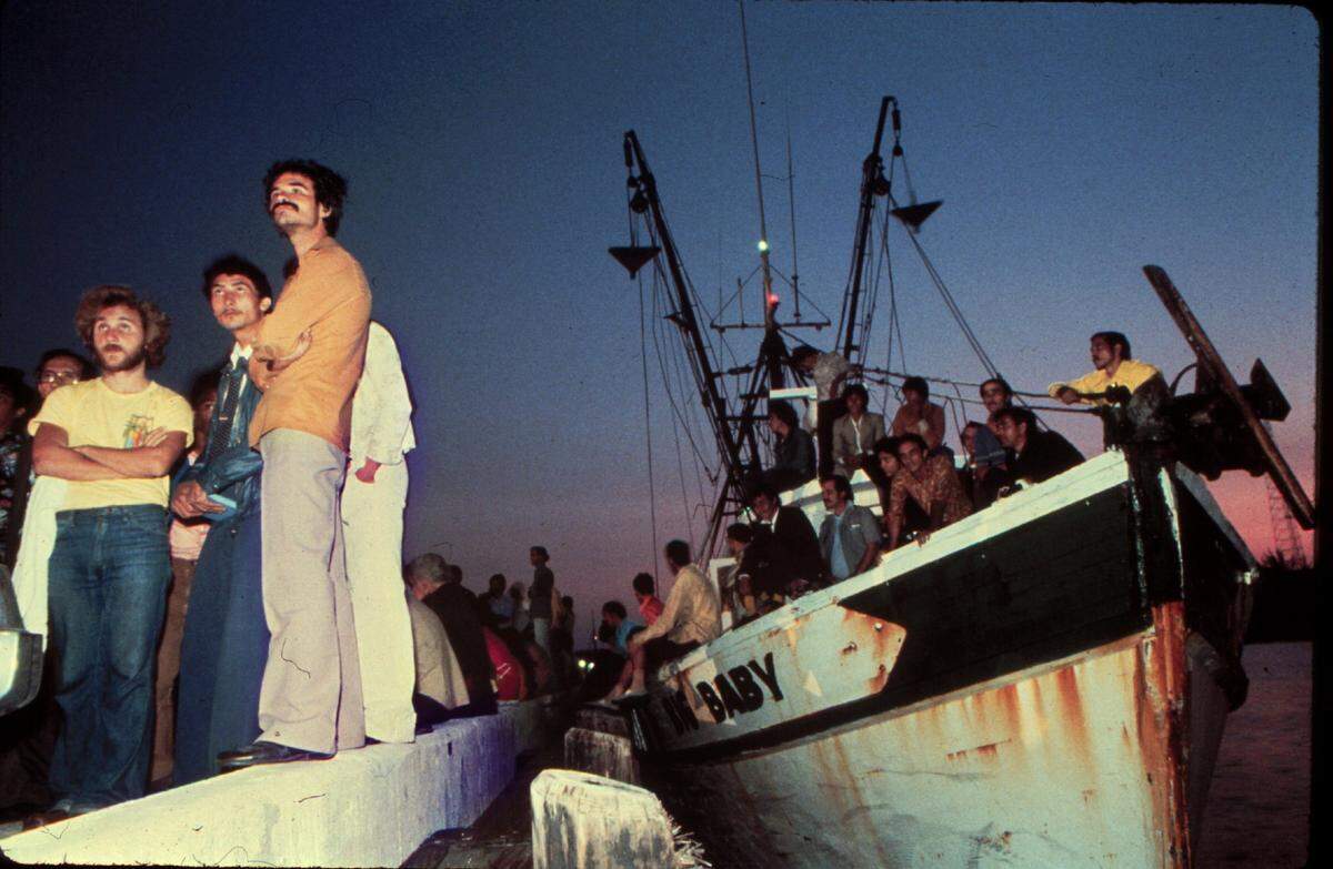In this file photo from April 23, 1980, Mariel refugees savor the new dawn over Key West Harbor and their first taste of freedom. The vessel “Big Baby” brought the boatload of Cubans from Mariel harbor.