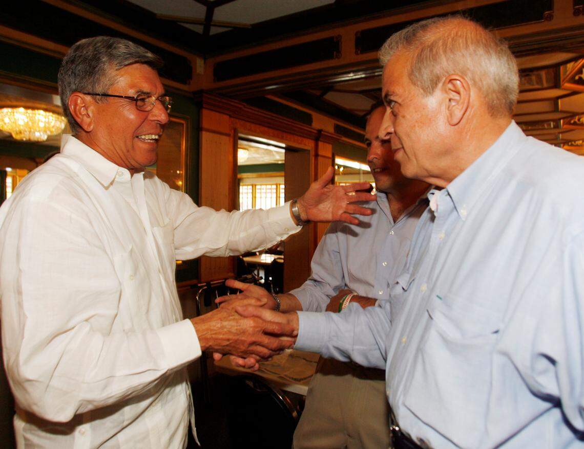 Manolo Reyes, then a City Commission candidate, greets Tomas Regalado, candidate for mayor, at the Versailles restaurant in Little Havana in November 2009.