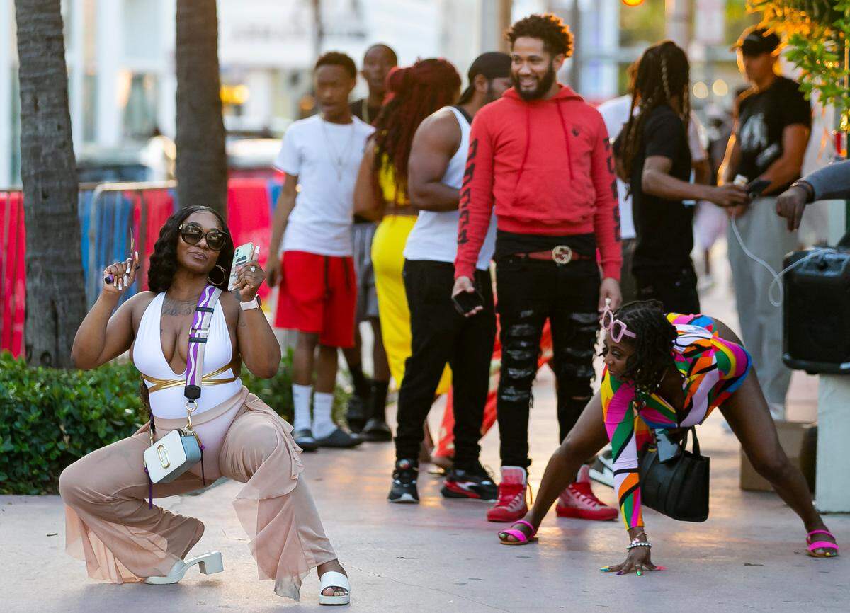 Two women twerk in Miami Beach, Florida on Friday, March 25, 2022. City officials imposed a midnight curfew and forced stores to stop selling alcohol after 6 p.m. The restrictions were set in place after two shootings in Miami Beach the weekend before caused city officials to announce a “state of emergency.”