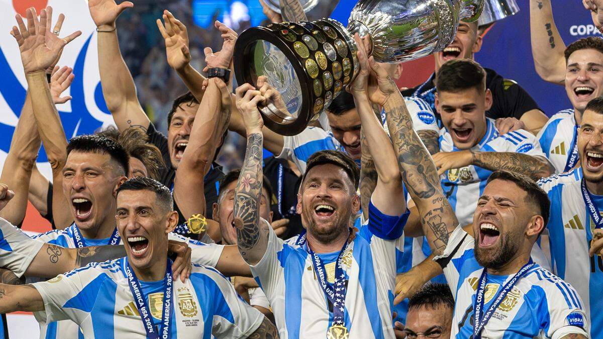 Argentina captain Lionel Messi (10) holds the trophy with his teammates after defeating Colombia in their Copa America 2024 Final at Hard Rock Stadium on Sunday, July 14, 2024, in Miami Gardens, Fla. Will he raise a Club World Cup trophy there with Inter Miami in July 2025? Time will tell.
