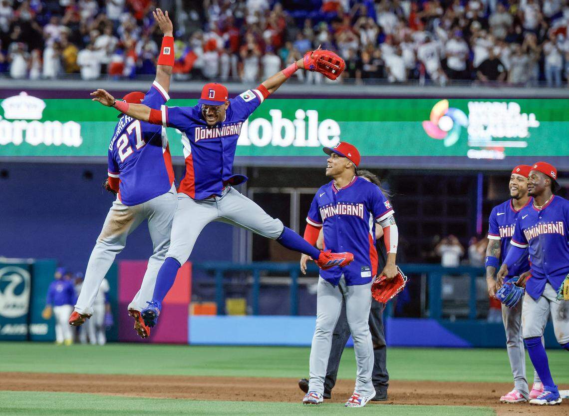 Dominican Republic first baseman Vladimir Guerrero Jr. (27) and center fielder Julio Rodríguez (44) leap in the air in celebration after defeating Venezuela during the World Baseball Classic at loanDept park on Wednesday, March 11, 2026.