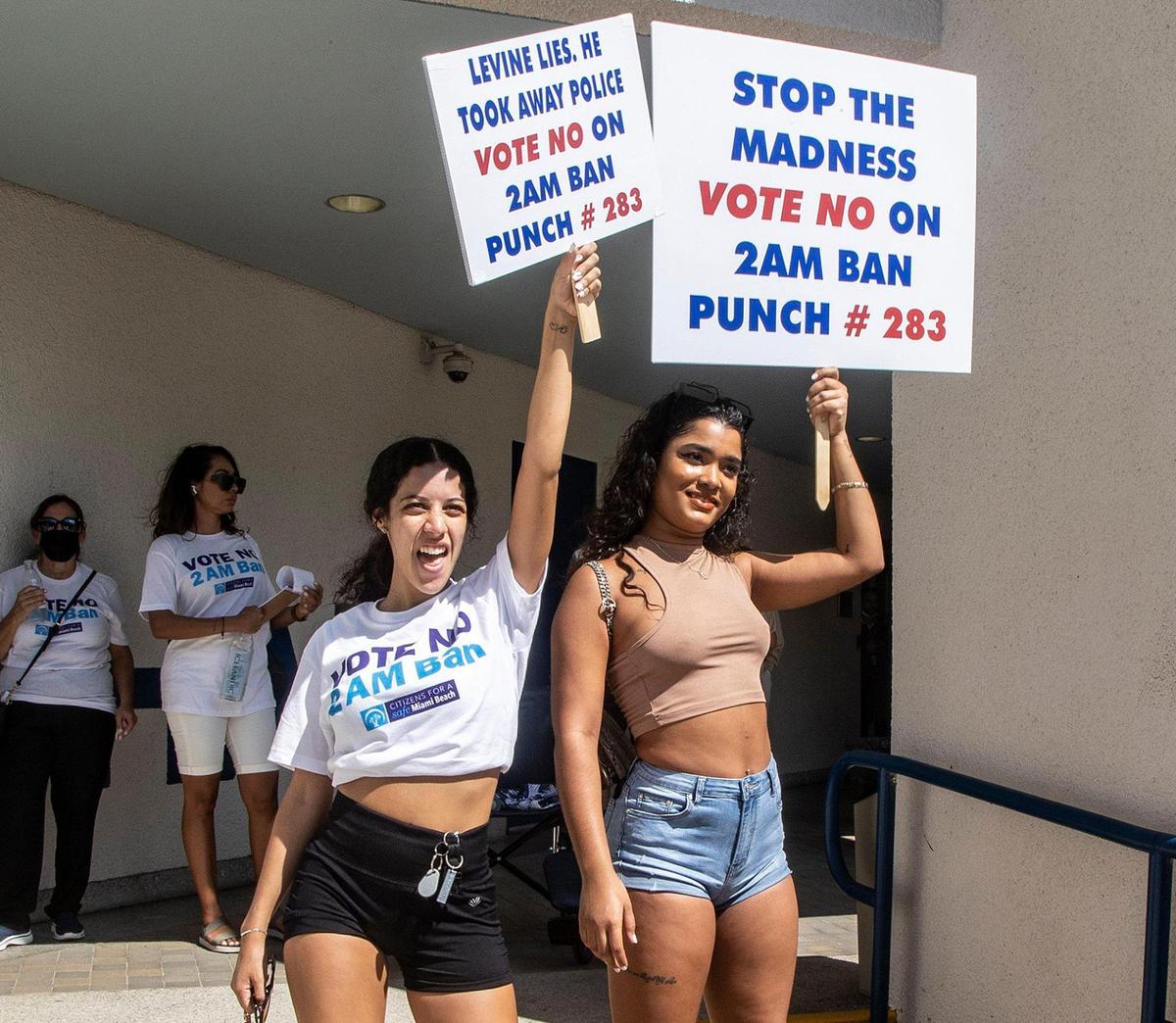 Adriana Perez and Adrienne Trinidad, who both work at Mango’s Tropical Cafe, join a group of hospitality workers protesting outside Miami Beach City Hall on Wednesday, Oct. 13, 2021, against the proposed 2 a.m. rollback of alcohol service across the city as part of a Nov. 2 referendum.