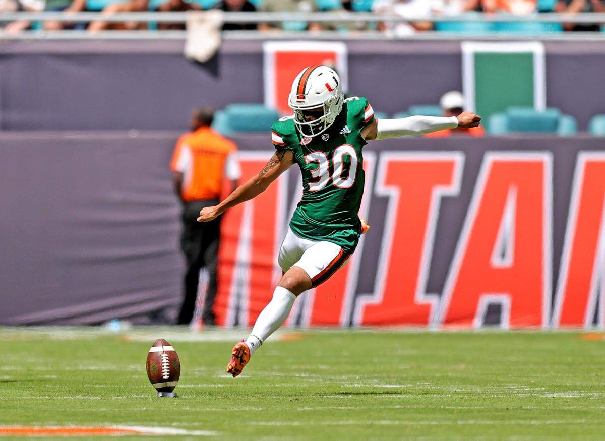 Miami Hurricanes place kicker Andres Borregales (30) kicks the ball on a kickoff during the first quarter of their ACC football game against the Central Connecticut State Blue Devils at Hard Rock Stadium on Saturday, September 25, 2021 in Miami Gardens, Florida.