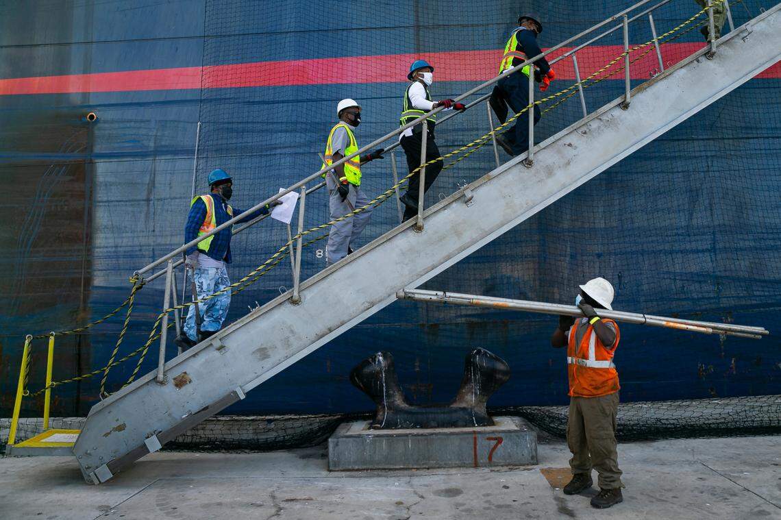 Longshoremen make their way onto a cargo ship at PortMiami on Saturday, February 20, 2021.