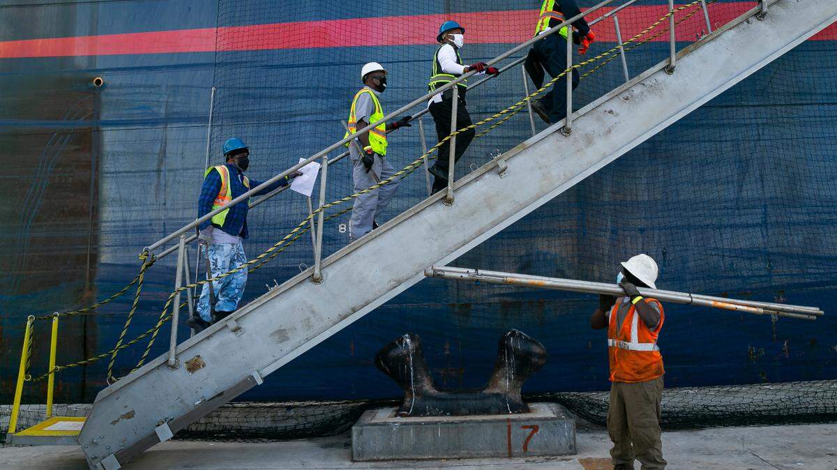 Longshoremen make their way onto a cargo ship at PortMiami on Saturday, February 20, 2021.