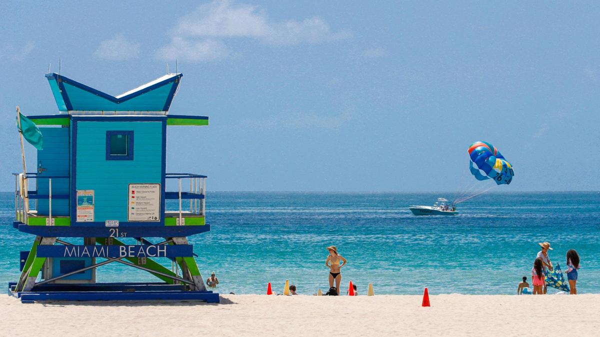 Beachgoers enjoy the high temperatures in Miami Beach on Monday, June 13, 2022.
