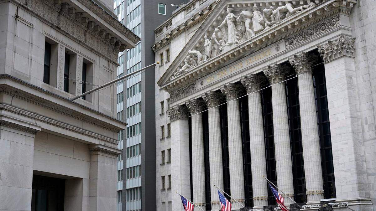 FILE - This Monday, Nov. 23, 2020 file photo shows the New York Stock Exchange, right, in New York. Stocks are drifting in mixed trading on Wall Street Tuesday, Dec. 22, 2020, after Congress finally approved a $900 billion rescue package for the economy. (AP Photo/Seth Wenig)