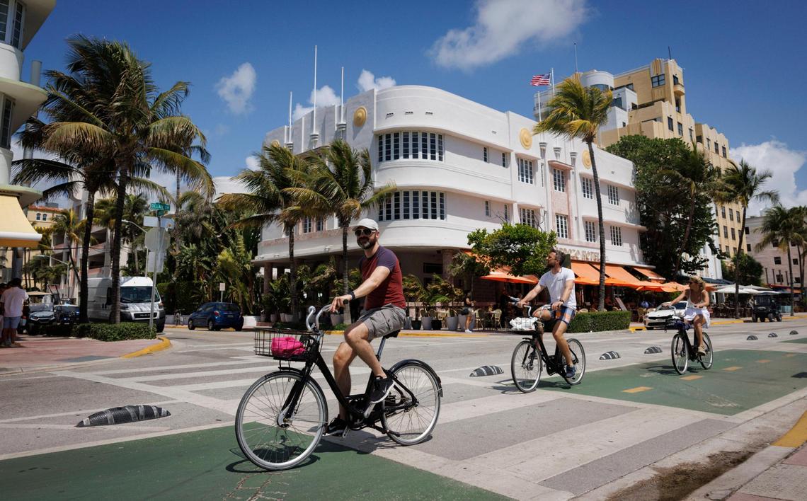People ride bikes down Ocean Drive outside the Cardozo Hotel in Miami Beach. Its owner, famed musician Emilio Estefan, urged legislators to amend bills that threaten it and other of the city’s architectural and historic treasures.