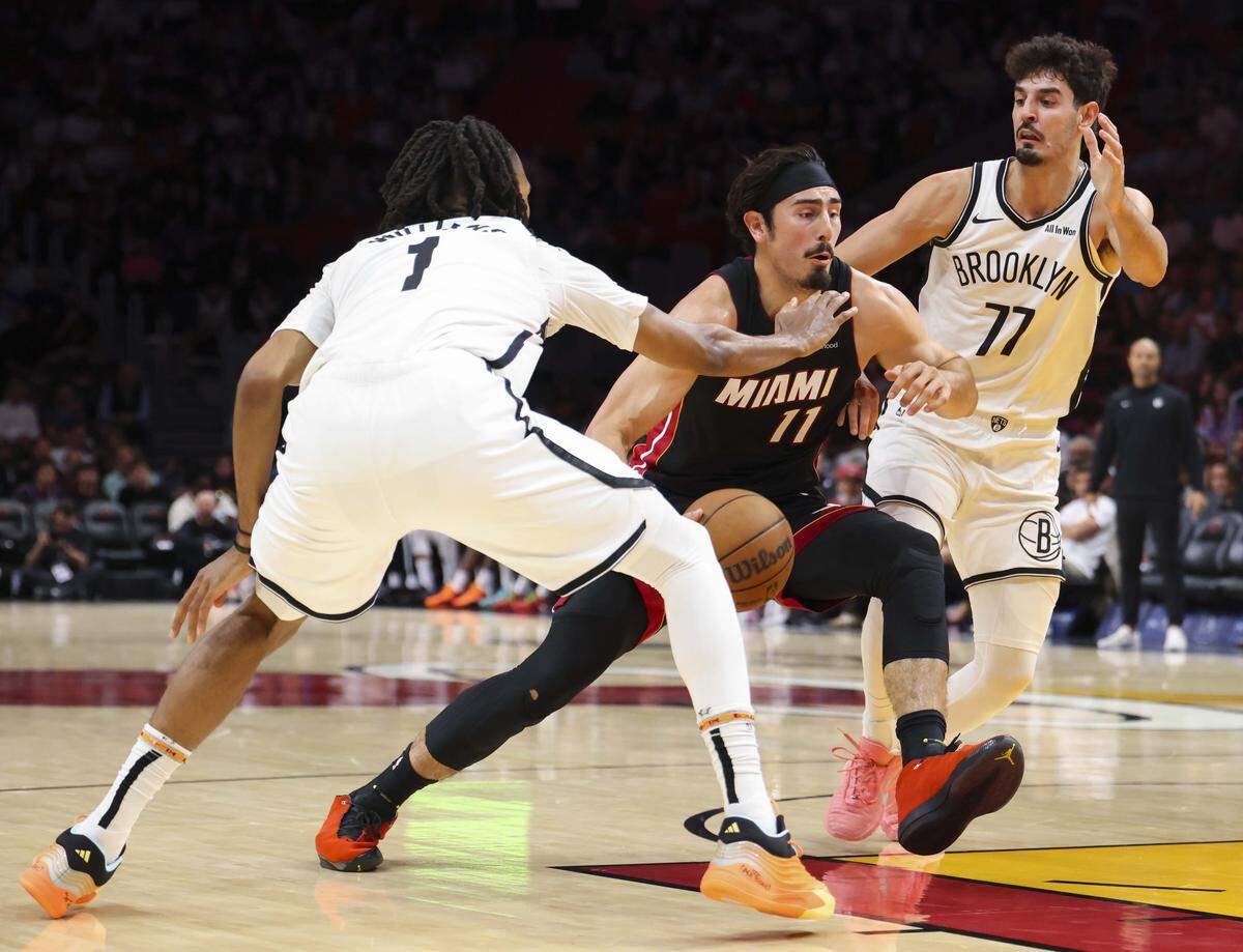 Miami Heat forward Jaime Jaquez Jr. (11) drives passed Brooklyn Nets guard Ben Saraf (77) and forward Ziaire Williams (1) during the first half of a game on Tuesday, March 3, 2026, at the Kaseya Center in downtown Miami, Fla. 