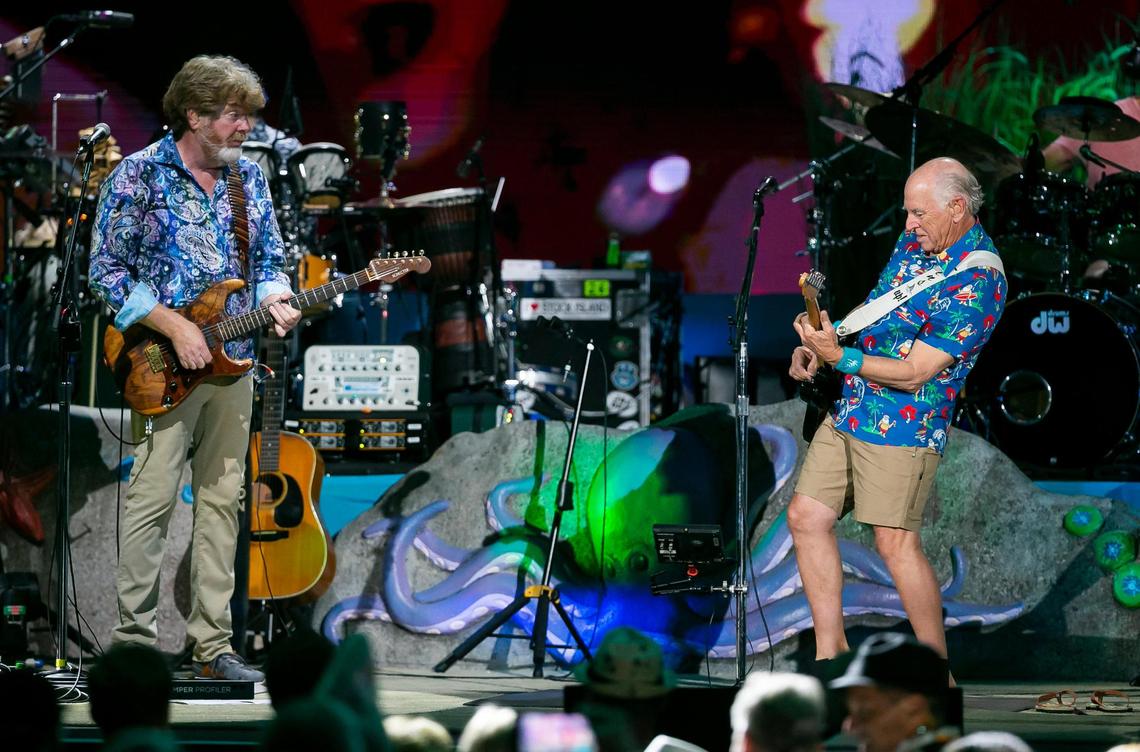 Jimmy Buffett (right) and his Coral Reefer Band, including Mac McAnally (left), perform during their concert at the iTHINK Financial Amphitheatre in West Palm Beach, Florida on Thursday, December 9, 2021.