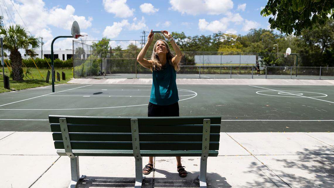 Jane Gilbert, Miami-Dade County’s chief heat officer, photographs the location of a heat sensor at Eaton Park on Saturday, Sept. 10, 2022, in Miami. Gilbert participated in a citizen science event, Shading Dade, where volunteers were tasked with placing heat sensors in specific locations across Miami-Dade County to help record heat temperatures.
