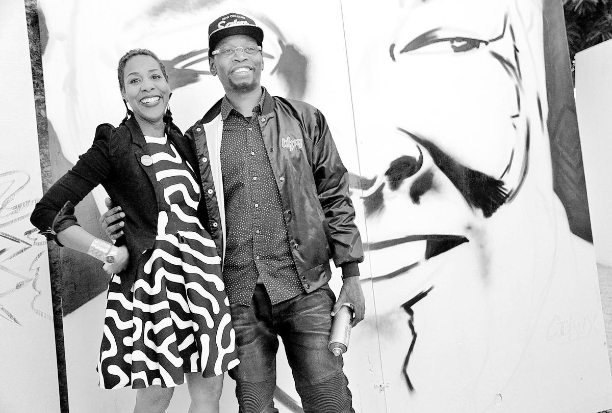 Curator Gia Hamilton with artist Courtney “Ceaux” Buckley as he paints a mural. He is one of a group of artists displayed at Afrofuture at The Urban Space in Overtown, one of the many art events and fairs taking place around Miami-Dade County during Art Basel Miami Beach, Dec. 5-9, 2018.