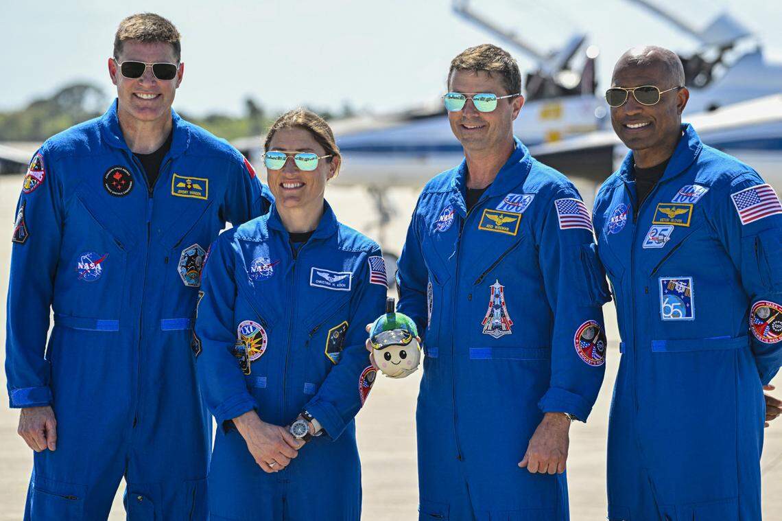 (L-R) Canadian Space Agency astronaut Artemis II Mission Specialist Jeremy Hansen, NASA astronaut and Artemis II Mission Specialist Christina Koch, NASA astronaut and Artemis II Commander Reid Wiseman and NASA astronaut and Artemis II pilot Victor Glover look on during a welcome ceremony ahead of the Artemis II April 1 launch at Kennedy Space Center in Florida on March 27, 2026. NASA and Canadian Space Agency astronauts assigned to the Artemis II mission arrive at Kennedy Space Center in Florida on March 27, 2026, to begin final pre-launch preparations for the first crewed lunar flyby in the Artemis program. The journey, set to last around 10 days, will take the astronauts on a loop around the Moon, though they will not land on its surface. The crew comprises the first woman, the first person of color and the first non-American to take part in such a journey. (Photo by Miguel J. Rodriguez CARRILLO / AFP via Getty Images)
