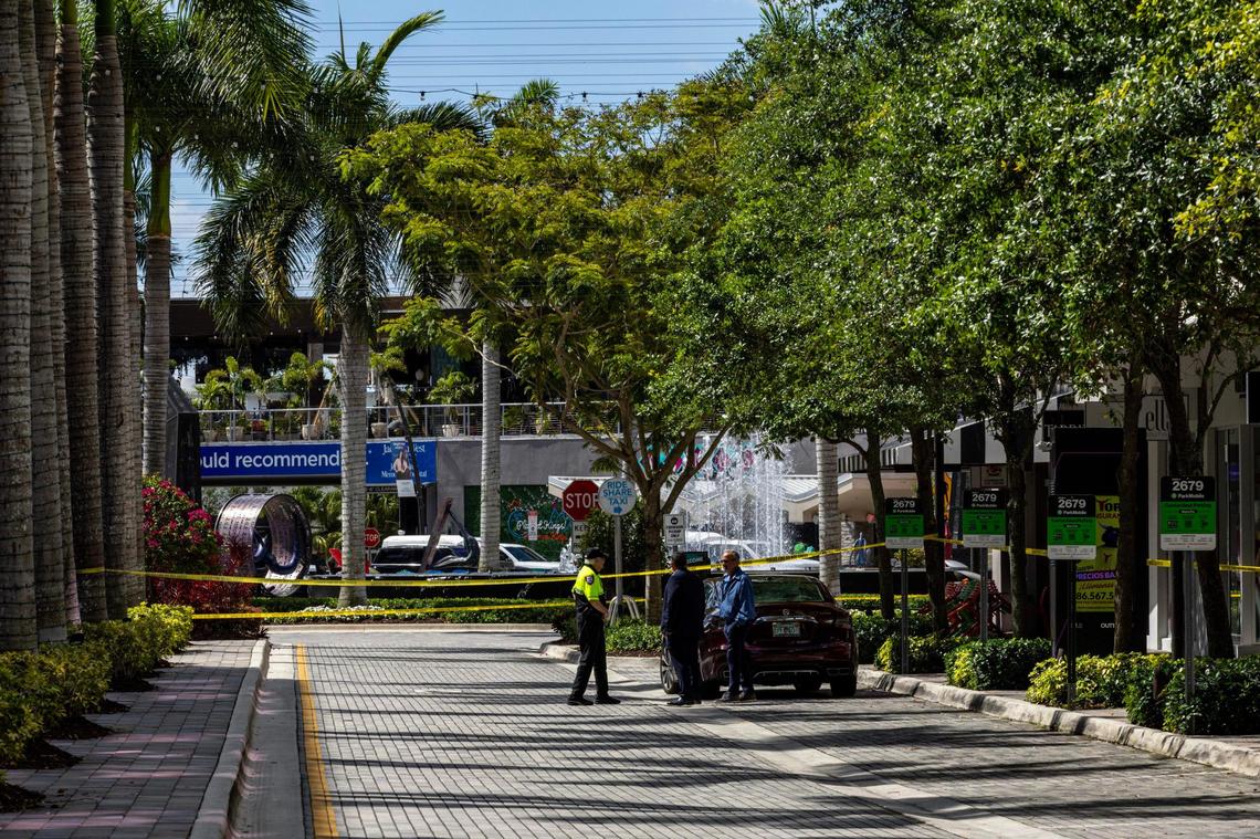 Yellow police tape hangs inside CityPlace Doral on Saturday, April 6, 2024.