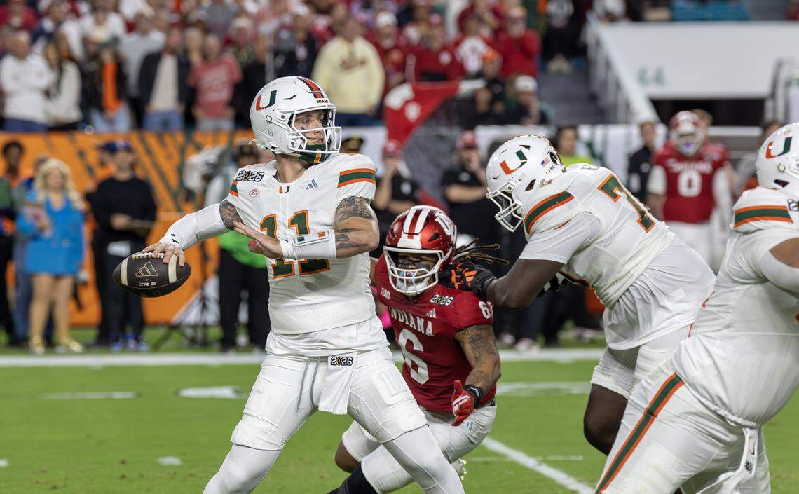 Miami Hurricanes quarterback Carson Beck (11) sets up to pass as offensive lineman Markel Bell (70) blocks Indiana Hoosiers defensive lineman Mikail Kamara (6) during the first half of the College Football Playoff national championship game Monday, Jan. 19, 2026, at Hard Rock Stadium in Miami Gardens, Fla.