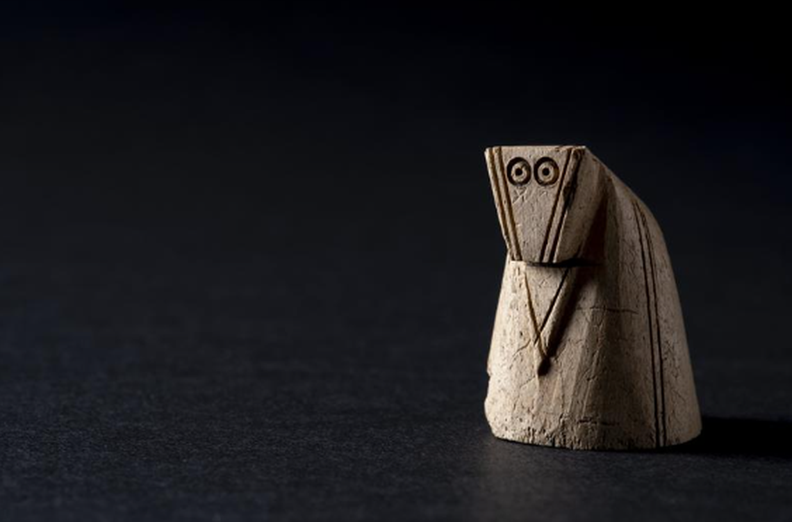 The chess piece was carved from antler and has an elaborate design.