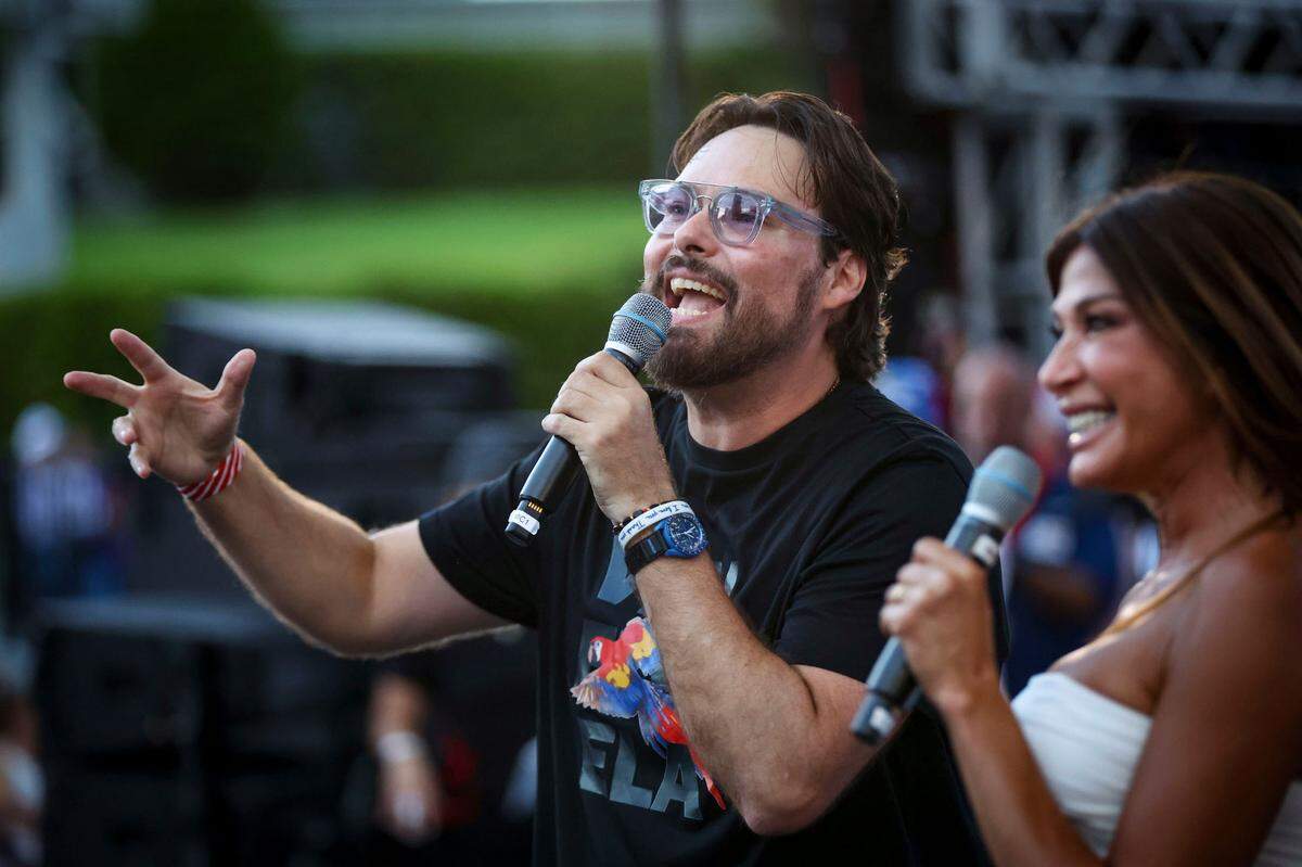 Miami, Florida, August 17, 2024 - Venezuelan Comedian George Harris, center talks to the crowd during the rally in Bayfront Park.