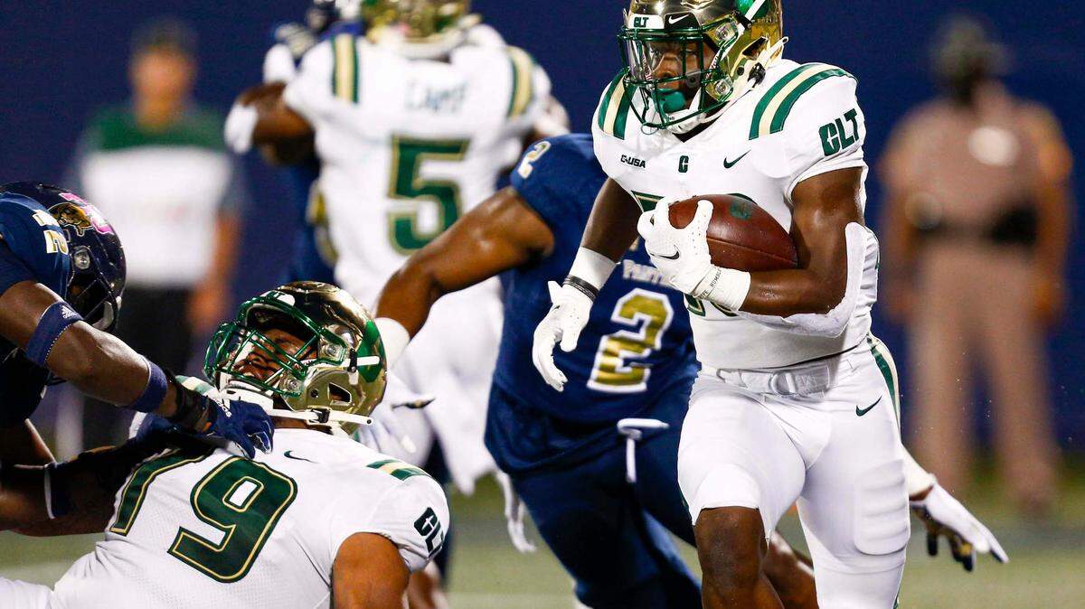 Charlotte 49ers running back Shadrick Byrd (13) is chased by FIU defensive linemen in Miami on Oct. 8. The 49ers host Florida Atlantic on Thursday.