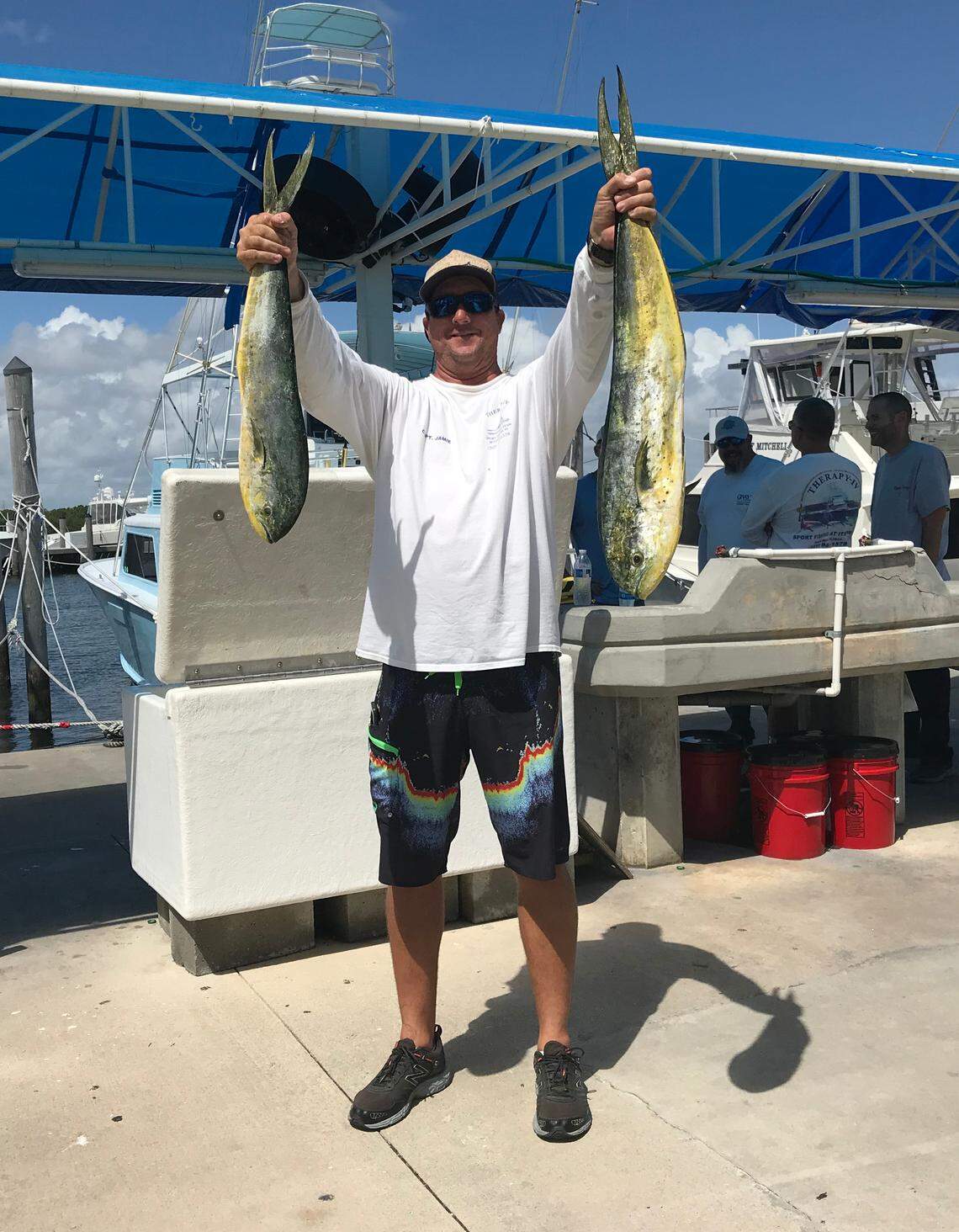 Captain Jamie Owens holds up two mahi-mahi fish caught Wednesday, Oct. 3, off Haulover Beach. That was just a day before Miami-Dade closed the beach after state tests confirmed the presence of red tide. Owens works for the Therapy IV charter outfit that runs out of the Haulover marina, which remained open on Thursday, Oct. 4, 2018.