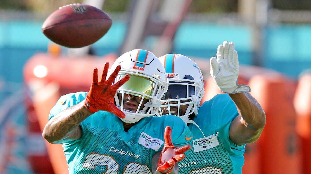 Miami Dolphins cornerback Jordan Lucas (23) and safety T.J. McDonald (22) at training camp at the Miami Dolphins training facility in Davie, Florida, August 12, 2018. 