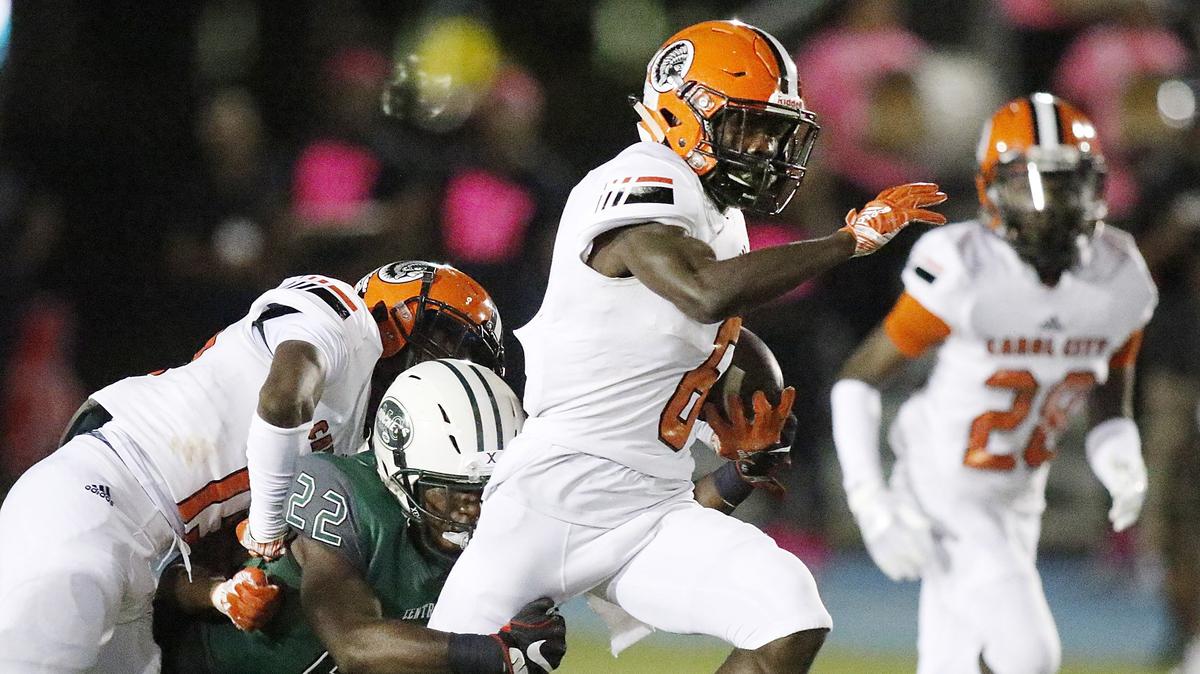 Carol City’s Chiefs’ wide receiver Amari Johnson (6) tries to break free from Miami Central Rockets defensive back James Donaldson (22) during the district 16-6A  championship football game on Friday, October 26, 2018 at Traz Powell stadium in Miami