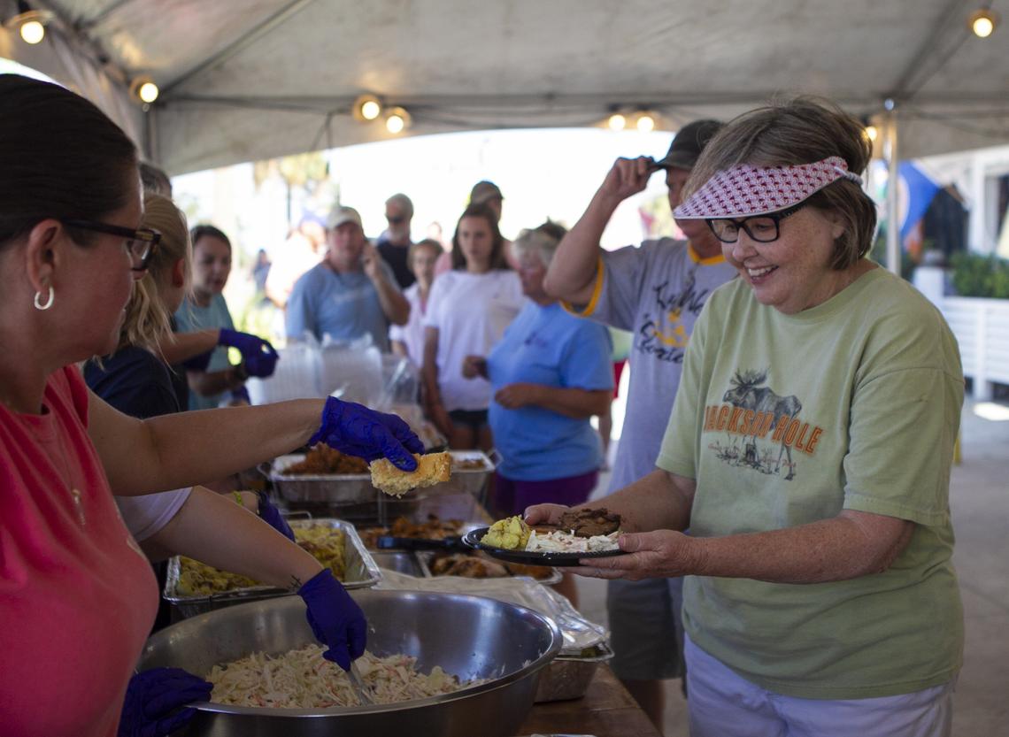 Pat Lowrey, 71, receives free food outside of Krazy Fish Grille in Port Saint Joe, Florida, one of the few places serving hot meals eight days after Hurricane Michael devastated the area leaving hundreds of thousands without shelter, power and food.