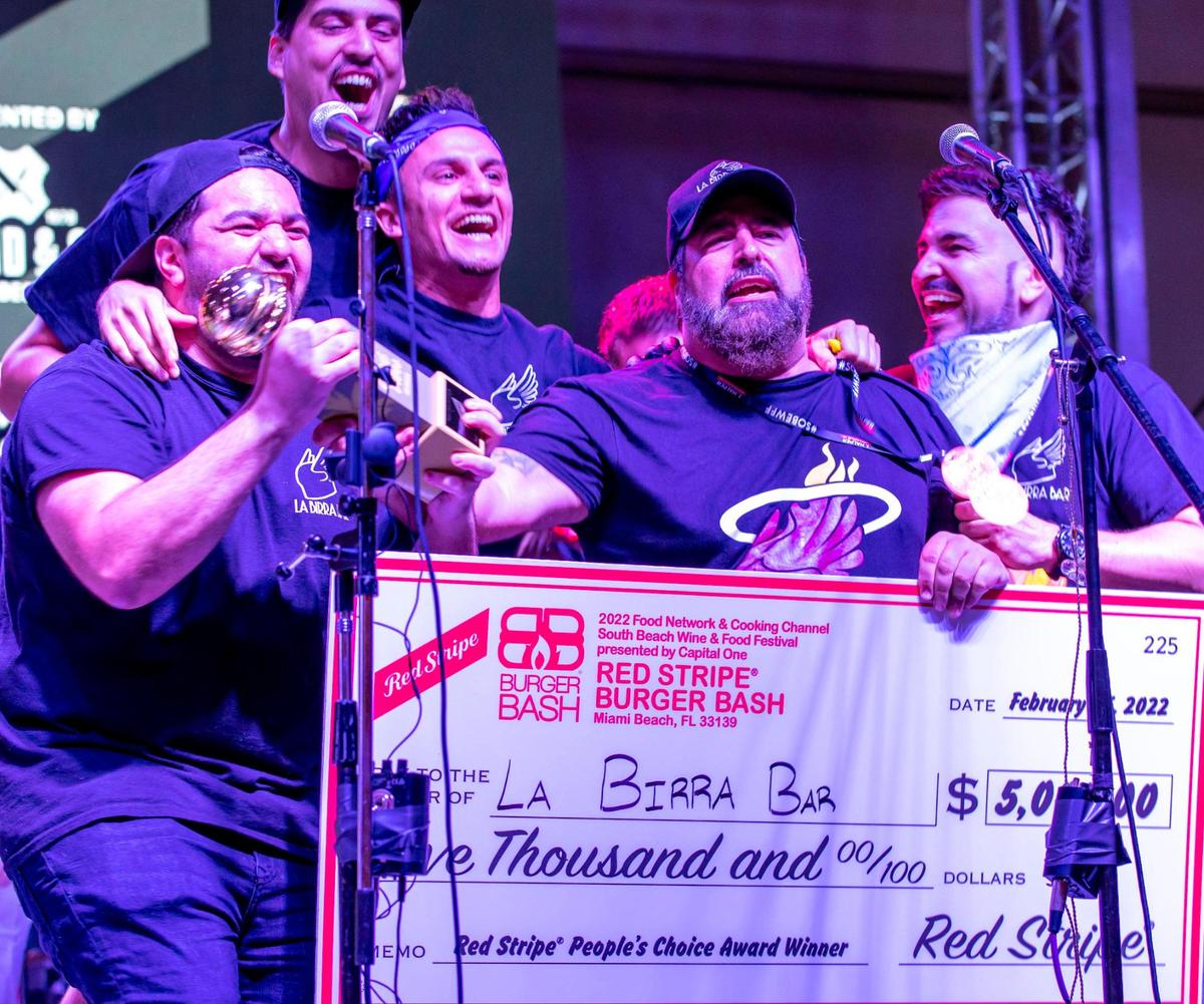 Winners of the People’s Choice award, La Birra Bar, react during South Beach Wine & Food Festival’s Burger Bash event in Miami Beach.