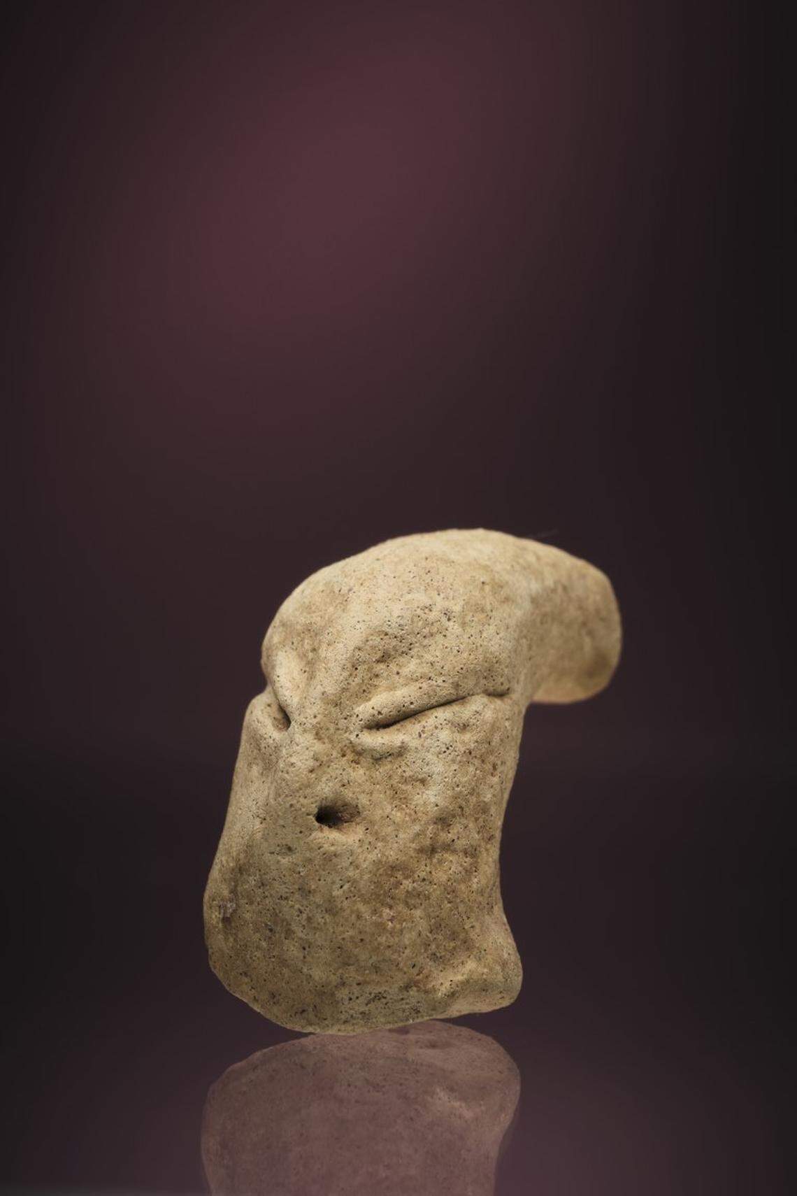 The figurine has an elongated skull, slanted eyes and a flat nose, researchers said.