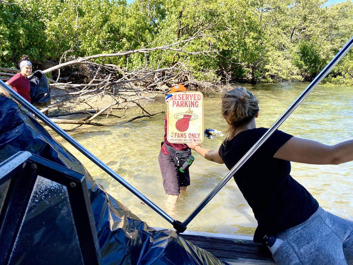A discarded parking sign for a Miami Heat fan somehow made its way to Bird Key in Biscayne Bay. It was found by volunteers among decades of trash on the island.